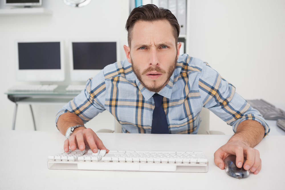 man unsure while on keyboard