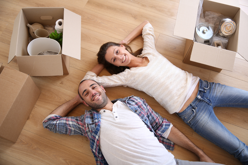 Couple laying on a hardwood floor